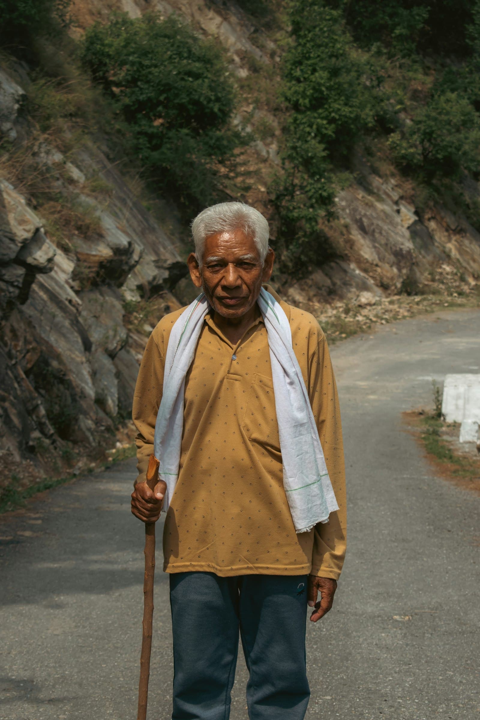 An older adult walking confidently outdoors in a park