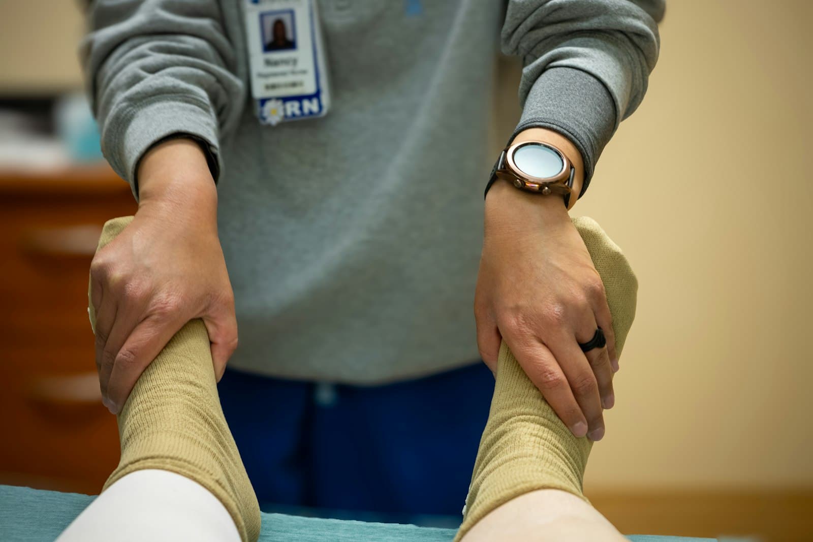 A physiotherapist assessing a patient's knee movement in a modern clinic