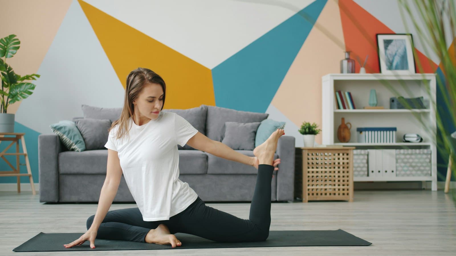Person performing a gentle back mobility exercise on a mat